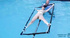 Blonde girl is tied to a rotating device that dips in pool!