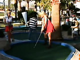 Blonde Angie plays golf with a sexy red dress and you can see her legs and boobs when she’s leaning