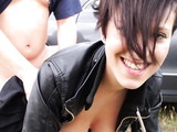 Short-haired babe in a black leather jacket gets fucked against a car on the side of the road
